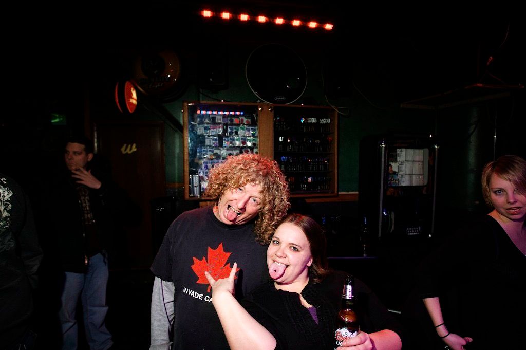 A crowded Sheboygan nightlife scene photographed in saturated color.