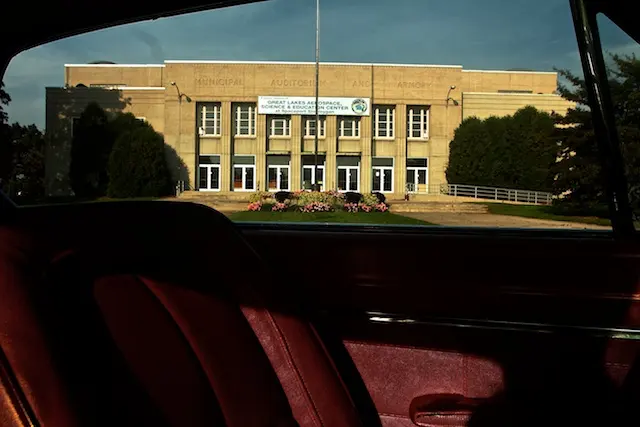 The big yellow-brick Sheboygan Municipal Auditorium and Armory, framed through a car window.