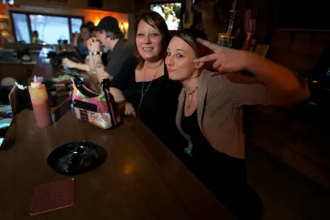 Friends mugging at the bar counter in Cascade.