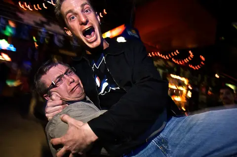Two guys horsing around mid-night-out at the Speakeasy.