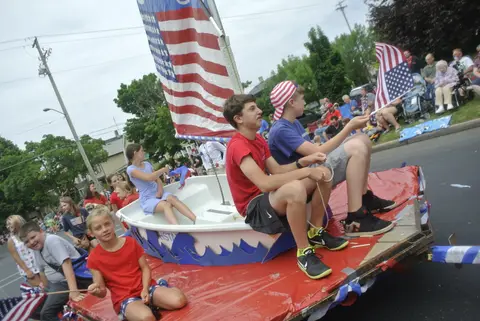 A boat on wheels flying a giant flag.