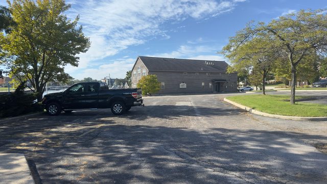 Empty lot beside a gray building on the Sheboygan riverfront