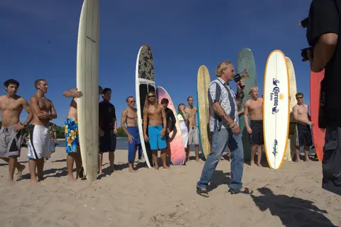 A beach full of surfers and longboards on Lake Michigan.