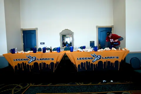 Contest tables under orange banners at the 1st Annual Legend Larry's Wing Eating Contest.