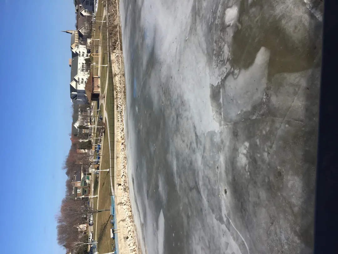 Frozen river with ice floes (Sheboygan area; exact reach UNVERIFIED). Photo: Michael Brunette.